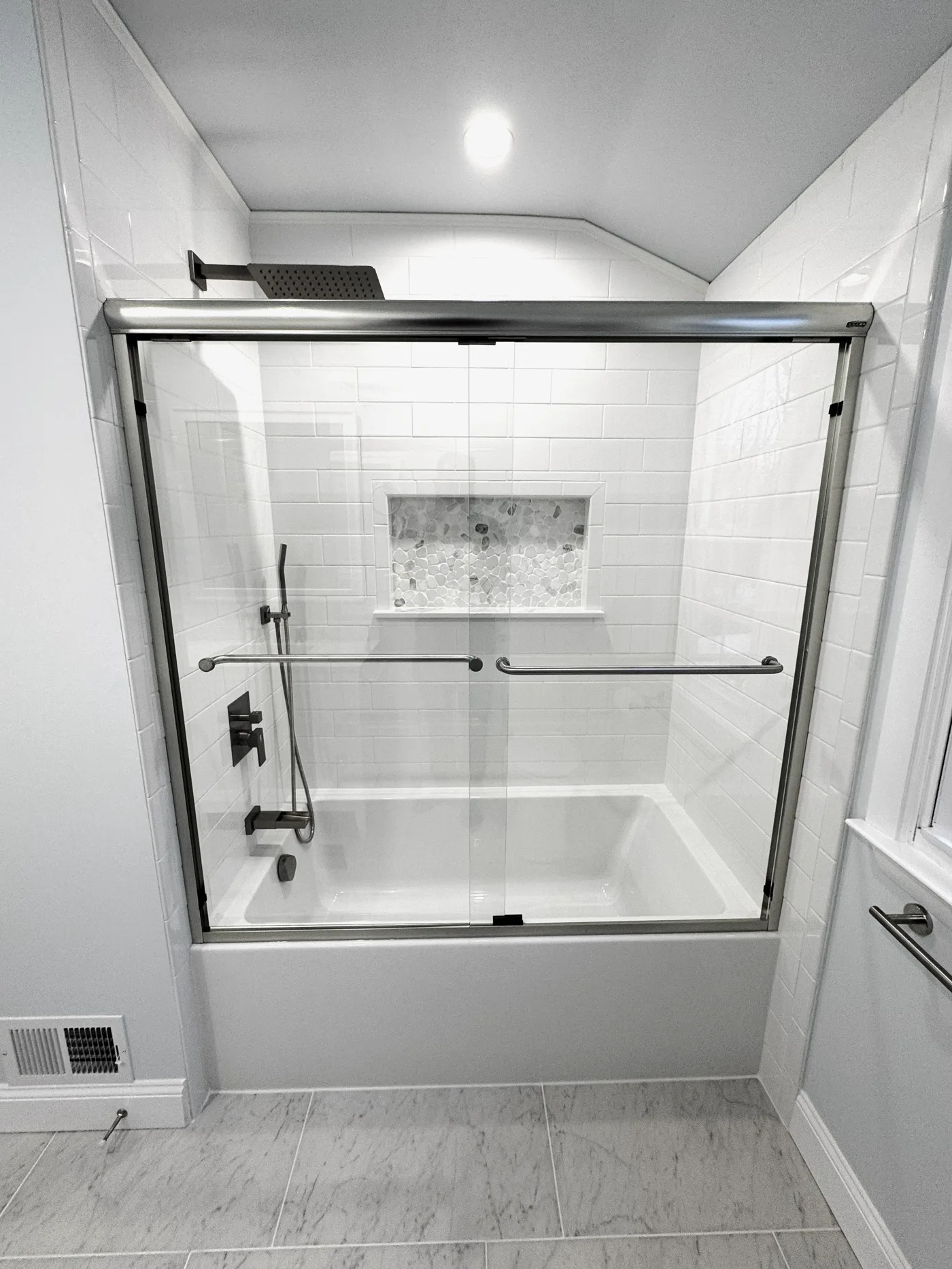 Custom bathroom tile remodel with subway tile and marble floor
