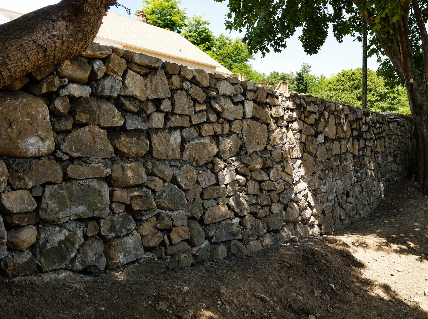 Ten-foot natural stone retaining wall at a Waterbury Connecticut home